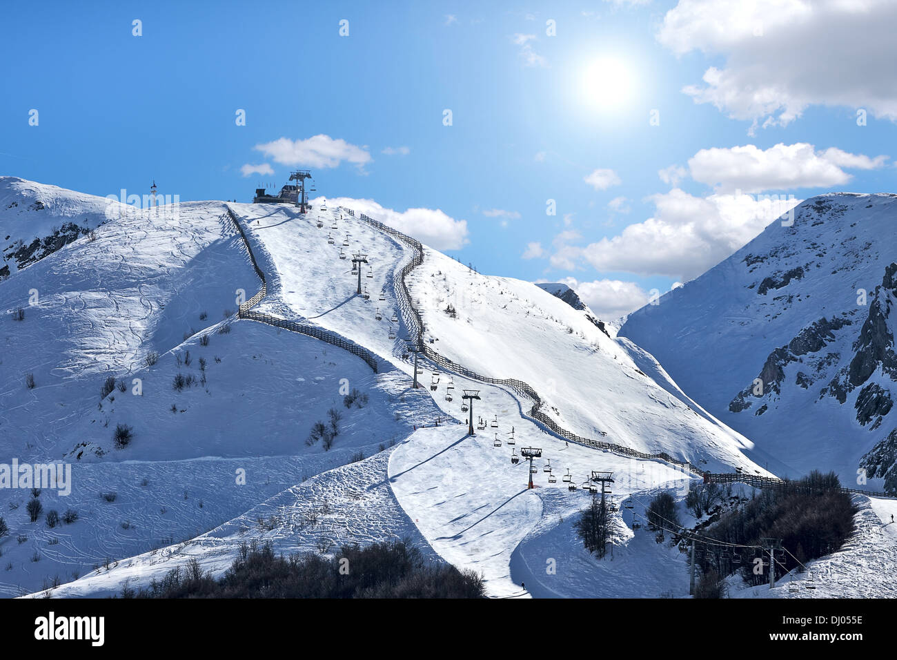 Mountains covered with snow and ski track on the slope in popular ...