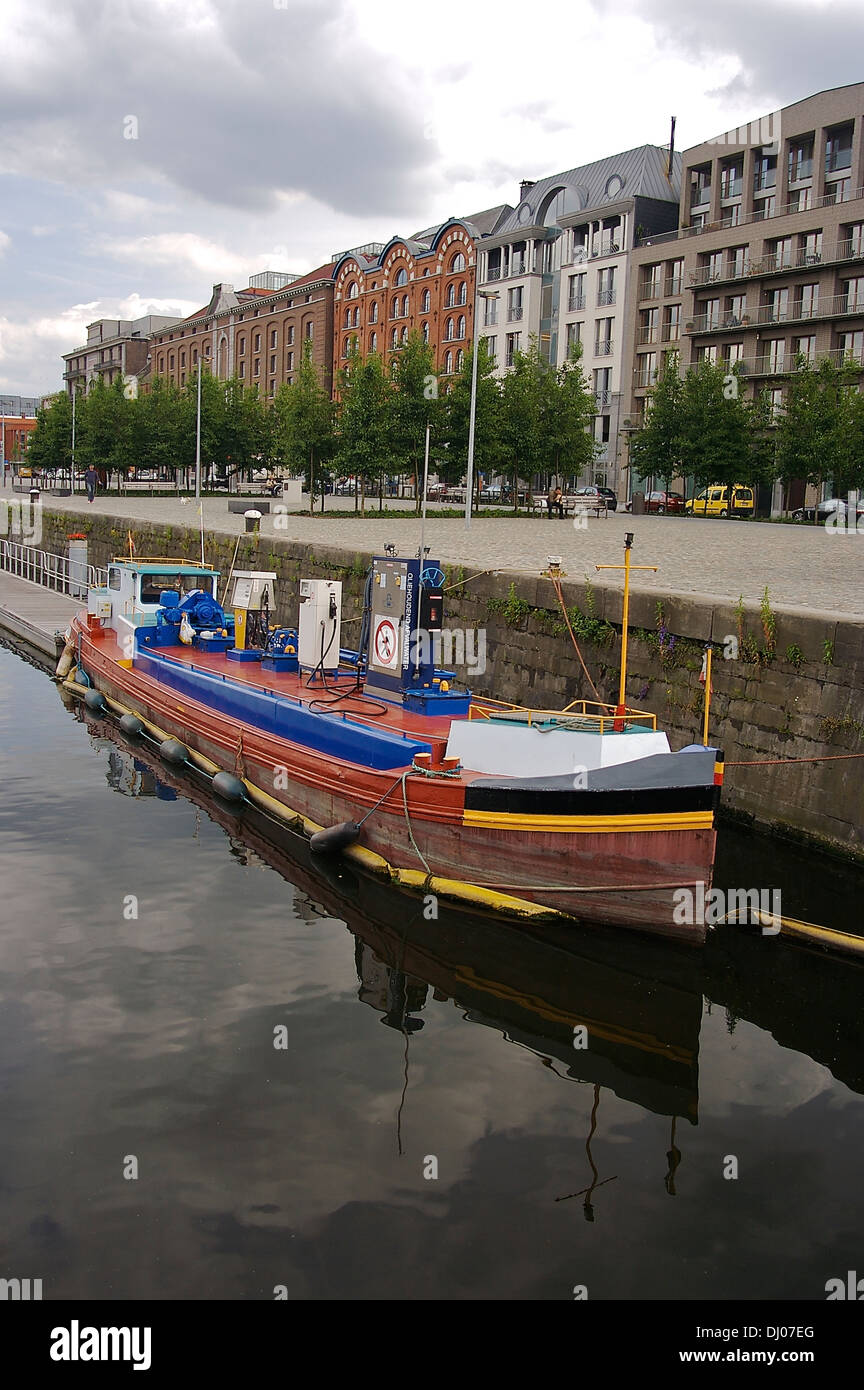 A small boat fitted with fuel pumps for use by other vessels is docked by an Antwerp quay Stock Photo
