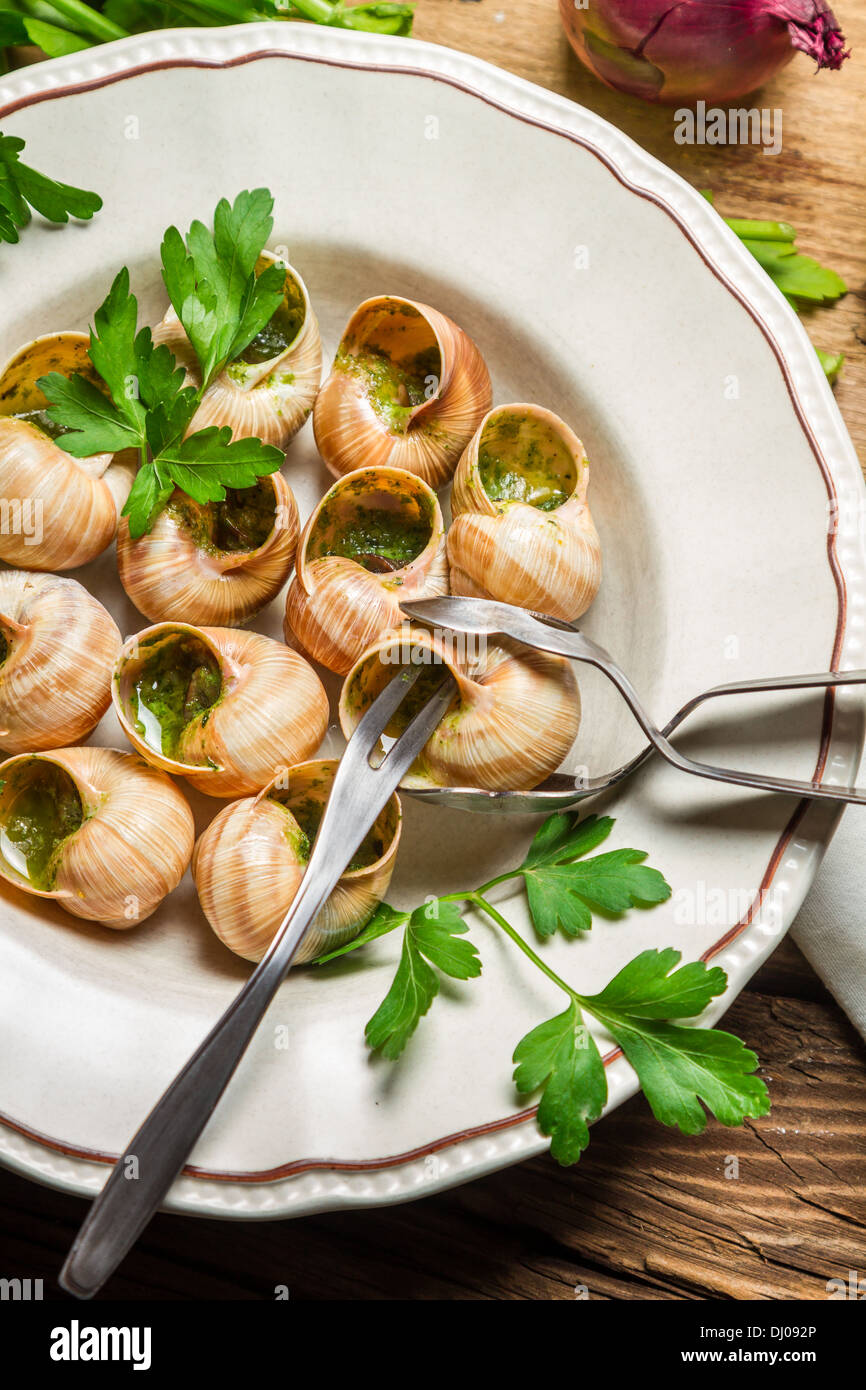 Eating the fried snails in garlic butter Stock Photo Alamy