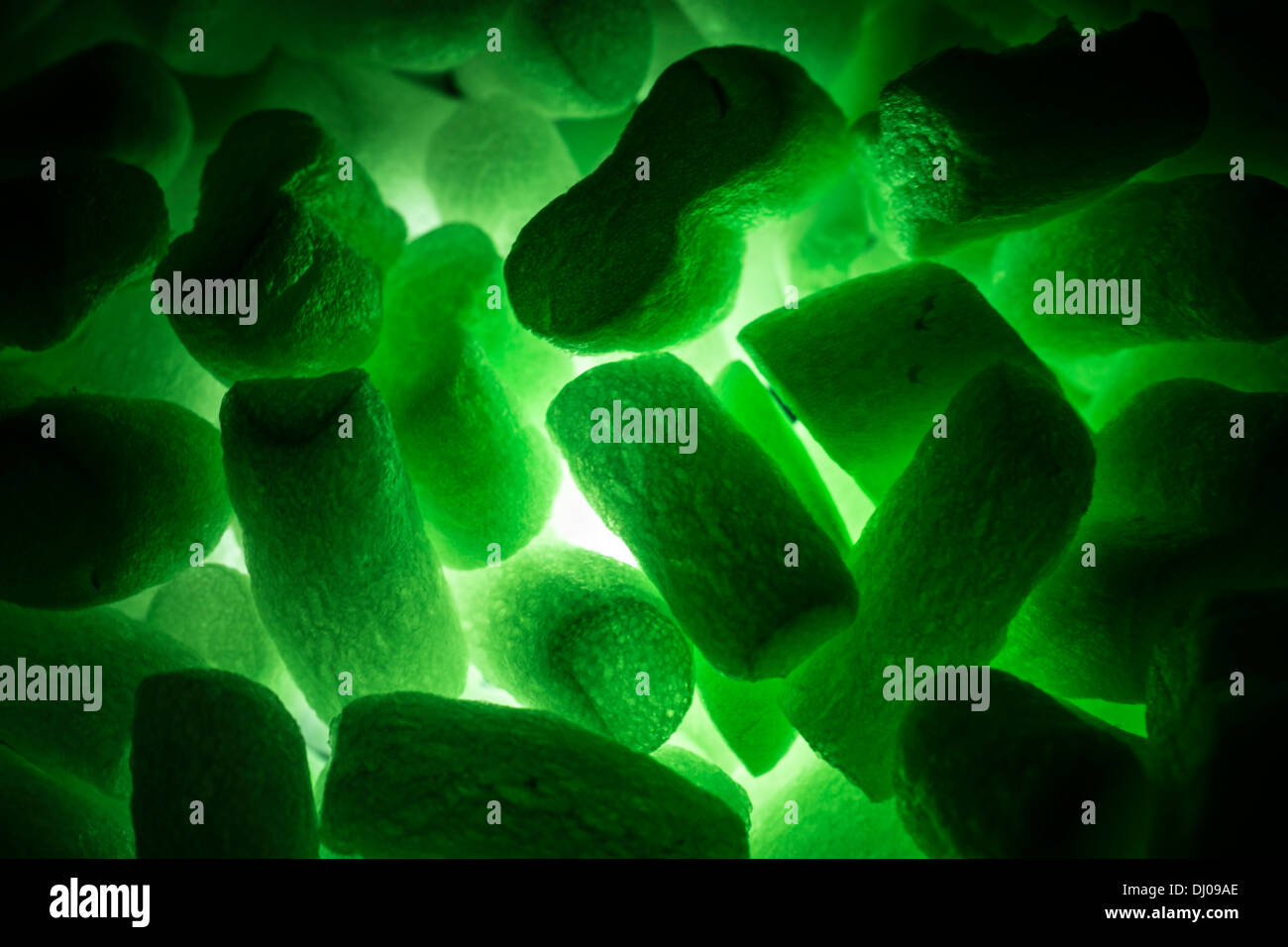 styrofoam packing peanuts glowing green Stock Photo Alamy
