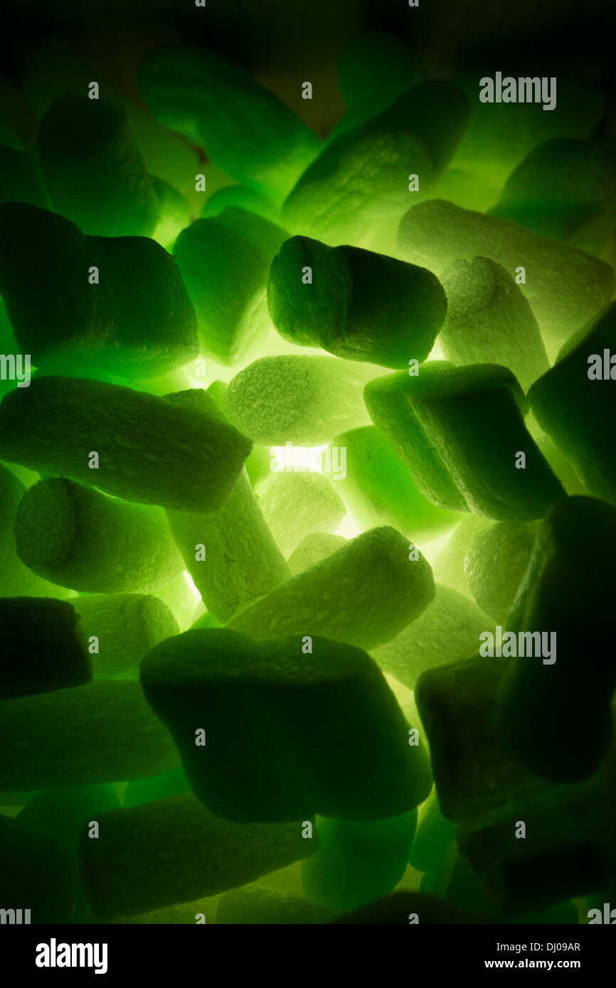 styrofoam packing peanuts glowing green Stock Photo Alamy
