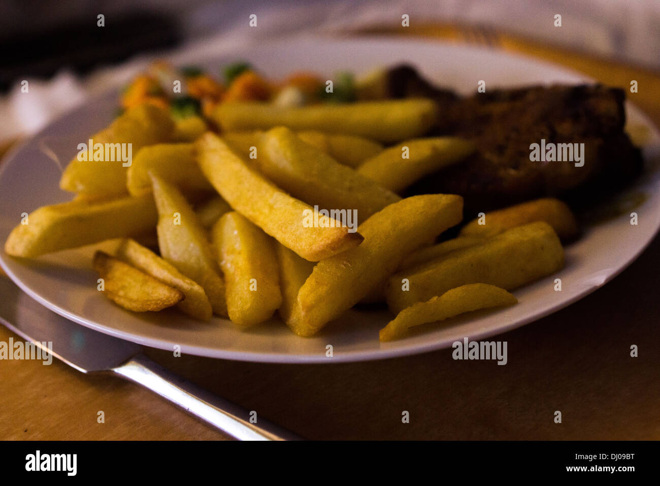 fresh food well done meat gravy fries chips plate Stock Photo