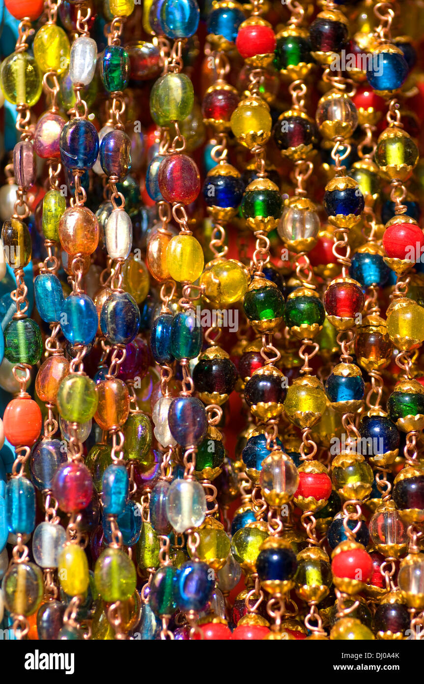 Multi coloured glass beads hanging on display and for sale in the village of Puttaparthi, A.P South India Stock Photo
