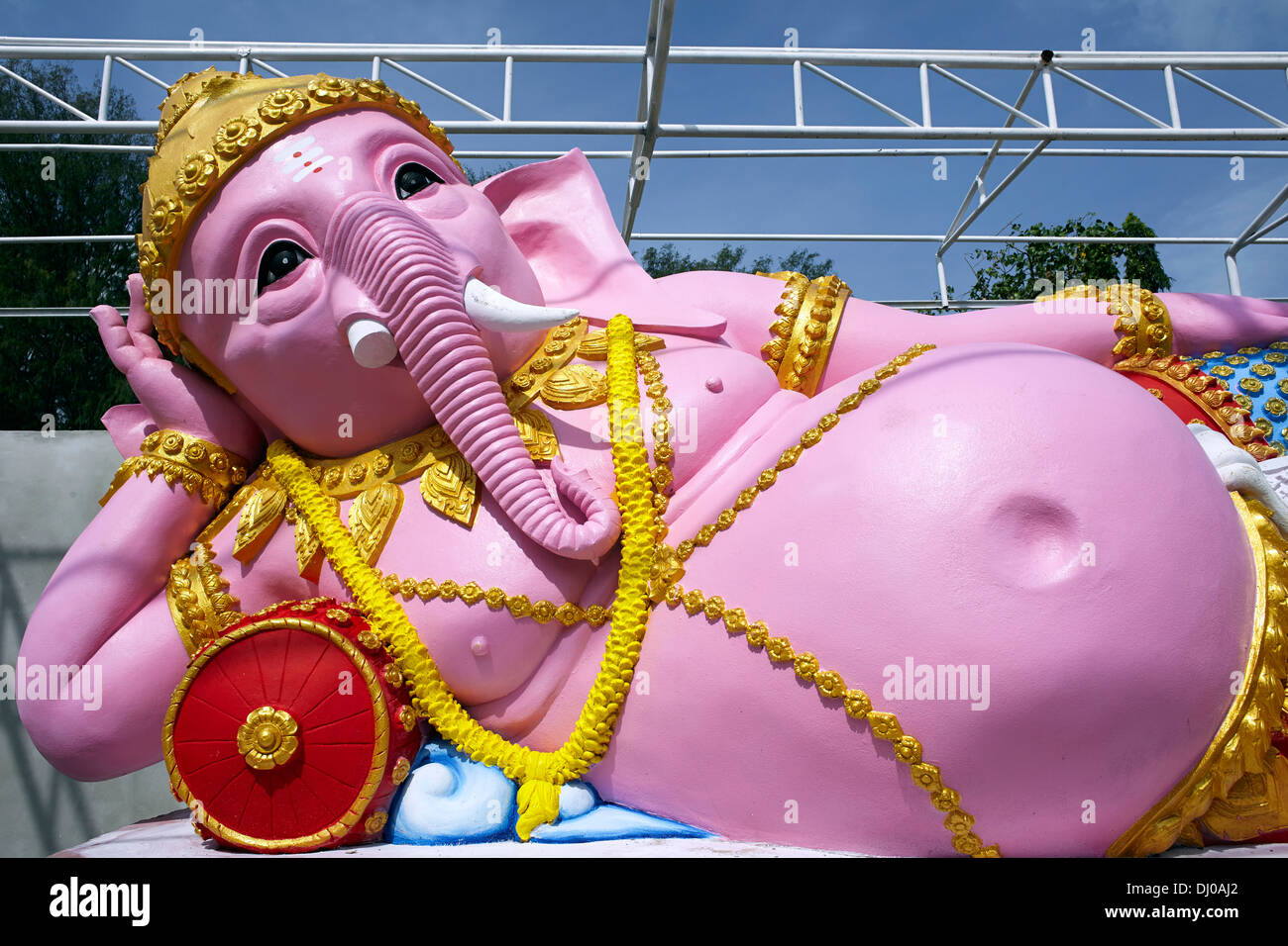 Ganesha elephant headed god; Reclining pink Ganesha deity statue Thailand S. E. Asia Stock Photo