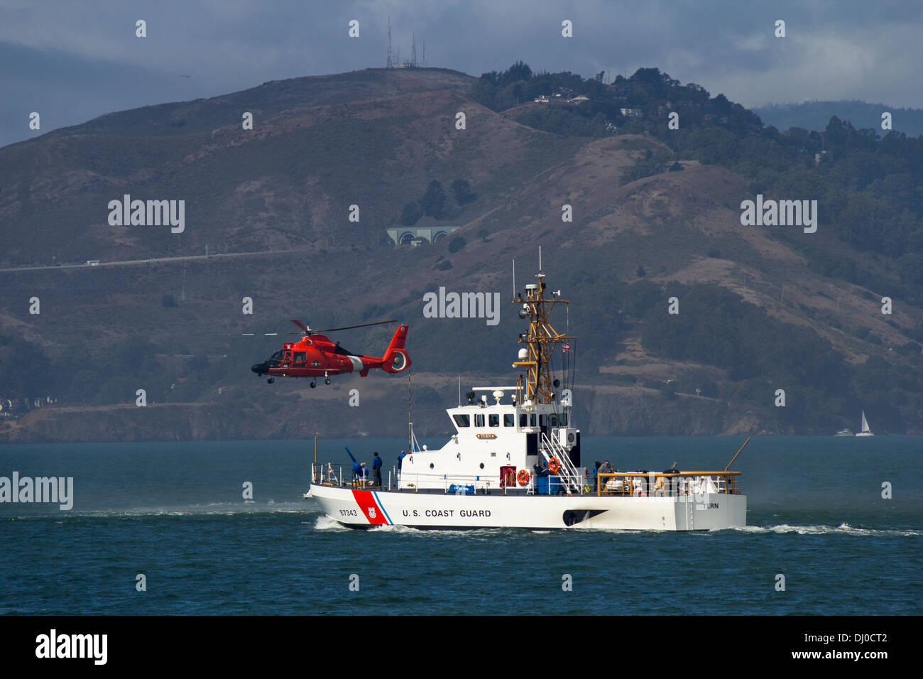 U.S. Coast Guard patrol boat and helicopter patrolling in San Francisco bay, San Francisco, California, USA. Stock Photo