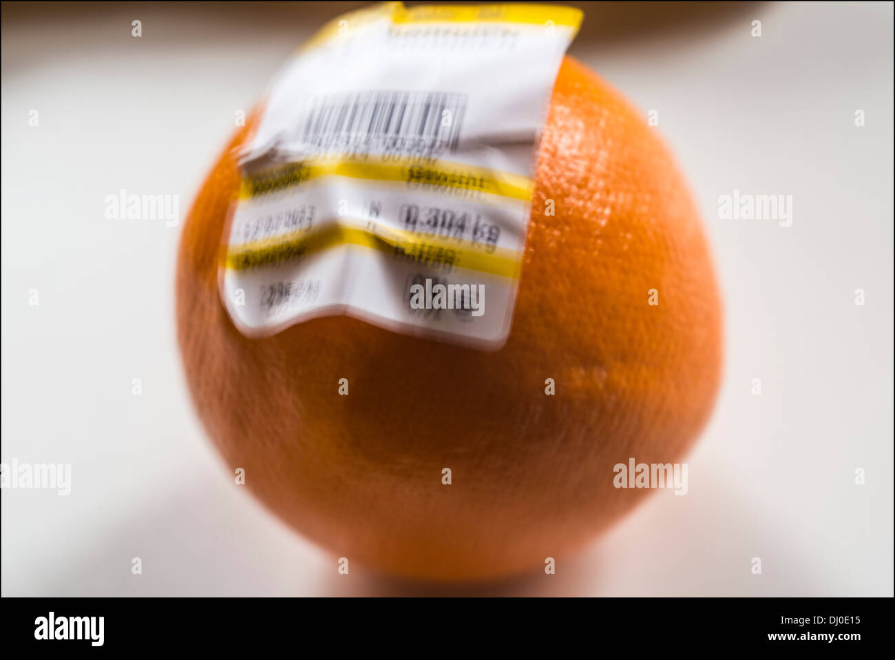 One orange with German barcoded label showing weight and price in Euro