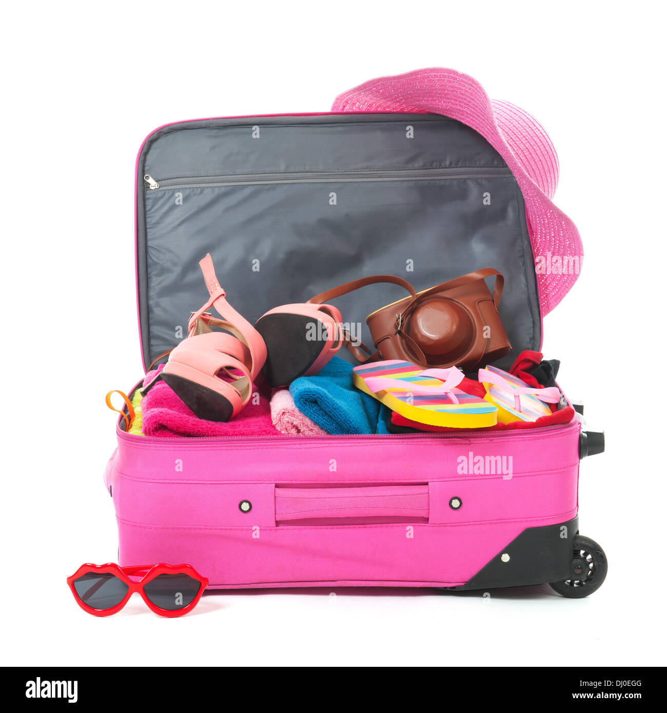 Packing the pink suitcase for the summer vacation Stock Photo