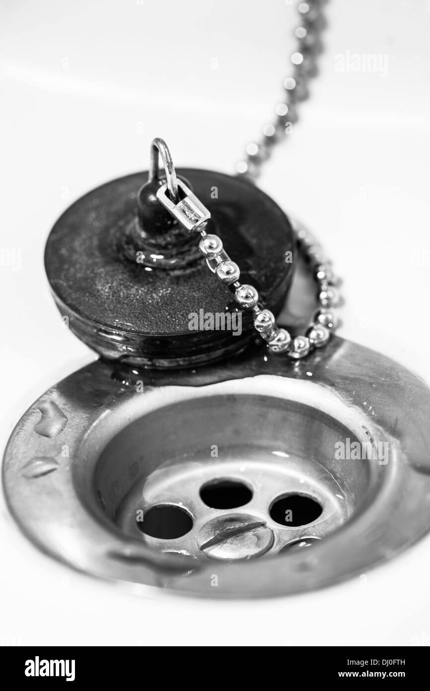 Sink and plug, vertical black and white image Stock Photo