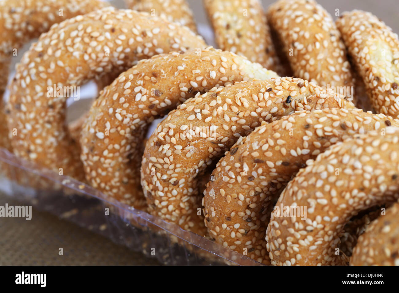 Round rusks with sesame seeds in plastic box. Stock Photo