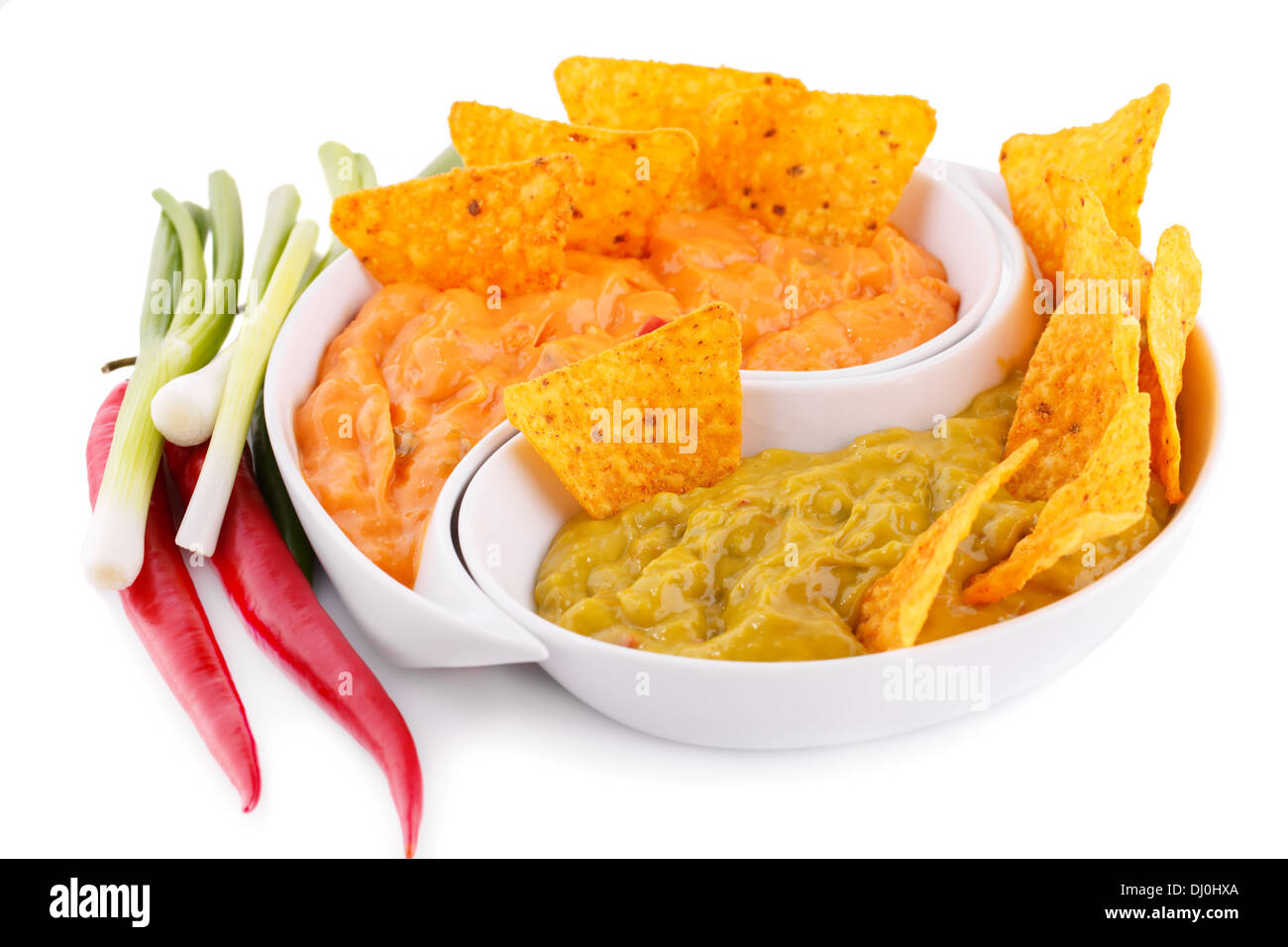 Nachos, guacamole and cheese sauce, vegetables isolated on white background. Stock Photo