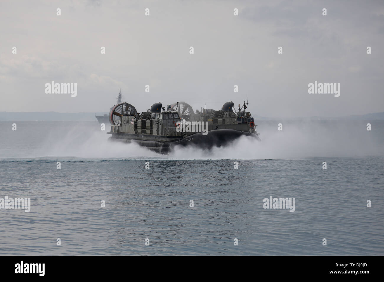 U.S. Sailors with the 31st Marine Expeditionary Unit, III Marine Expeditionary Force, use a Landing Craft Air Cushion to load gear and equipment onto the USS Germantown at U.S. Navy White Beach Port Facility, Okinawa, Japan, Nov. 16, 2013. The Marines and Stock Photo