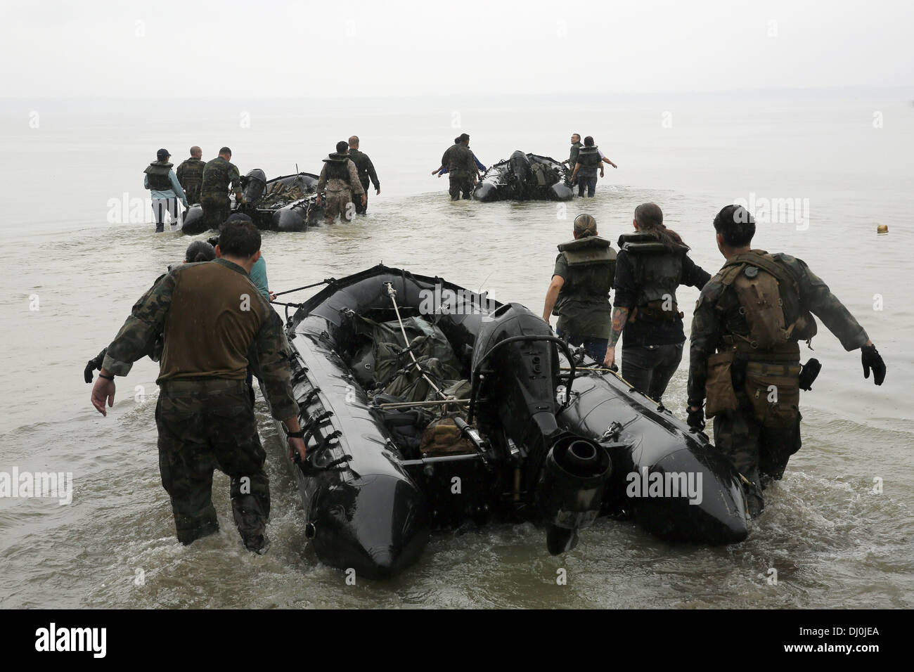 US Marine Corps Special Operations commandos prepare to transport participants of a Jane Wayne Day event via zodiac boats October 19, 2013 in Camp Lejeune, NC. The event allowing wives of MARSOC personnel to experience firsthand mission training. Stock Photo