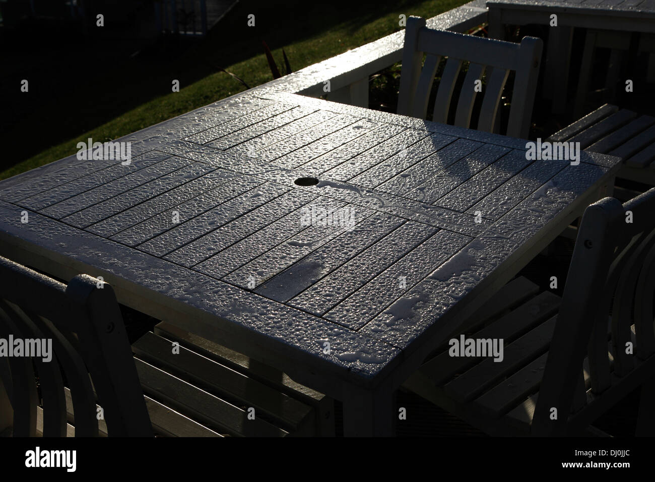 Early morning sun shining on wet table Norton Grange Isle of Wight Hampshire England Stock Photo