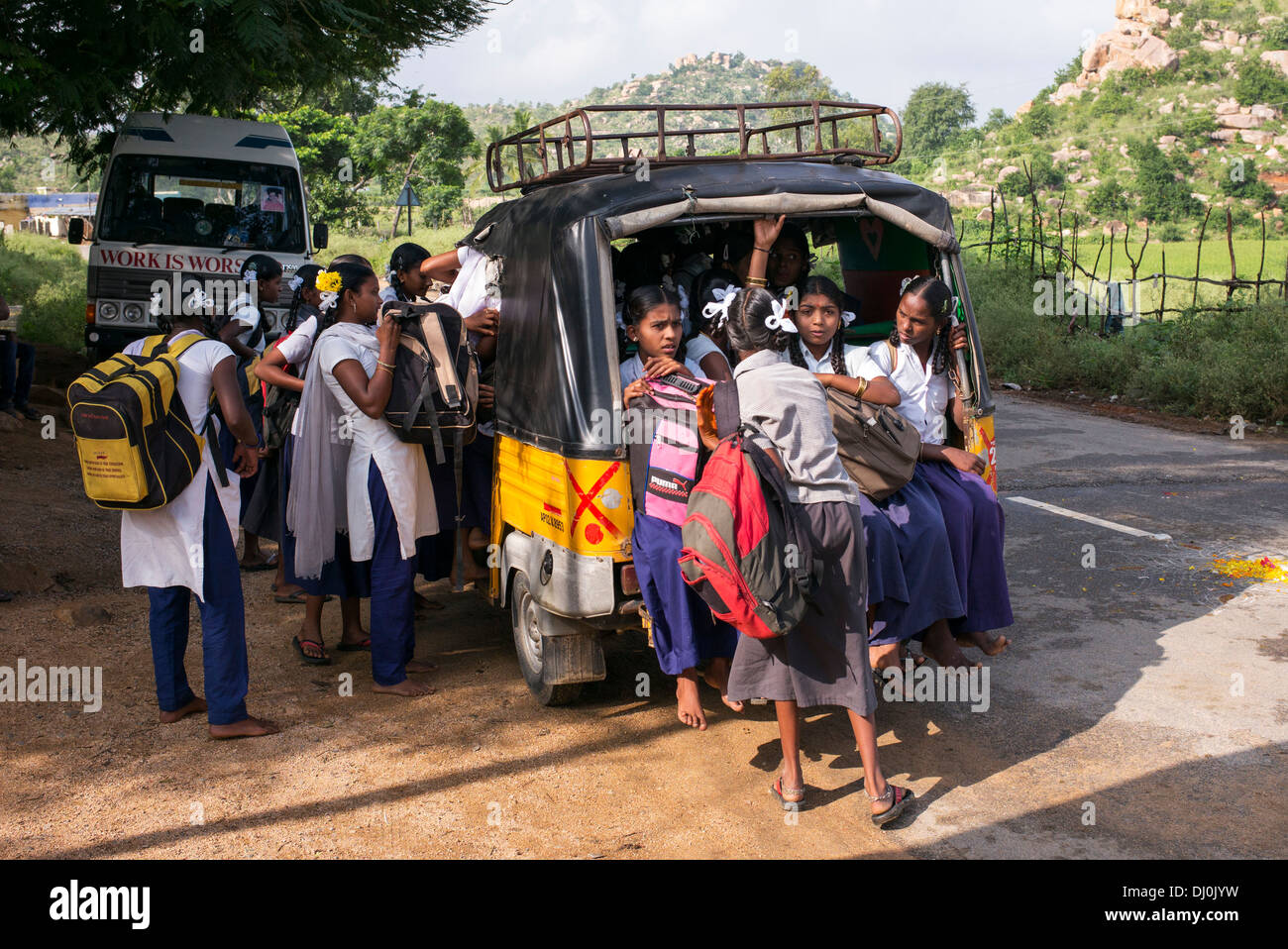 Indian girls getting into a rickshaw to go to school school. Andhra Pradesh, India Stock Photo