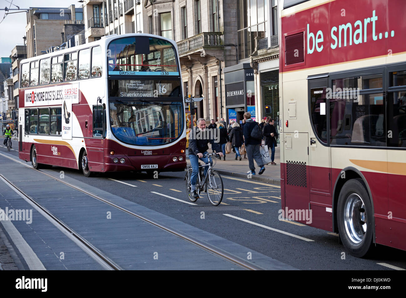 Buses and cyclist Edinburgh Princes Street Scotland UK Stock Photo
