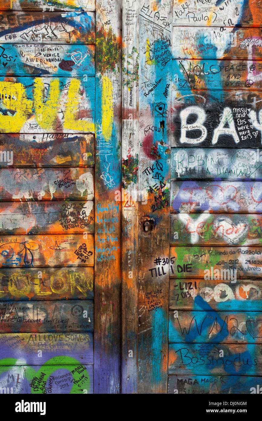 John Lennon wall in Prague. Wooden entrance door. Stock Photo