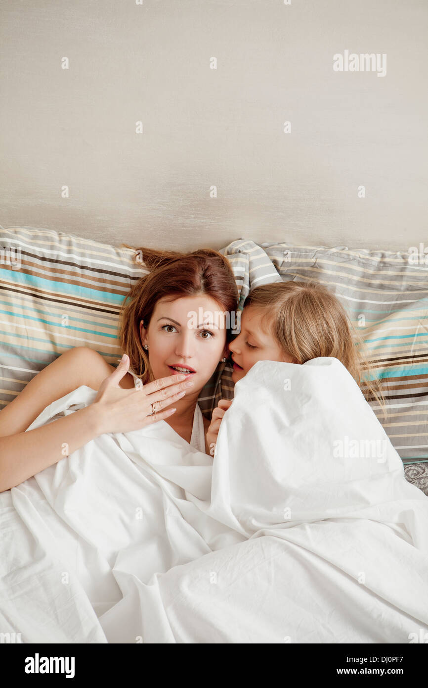 mother and daughter lying in bed,wonder Stock Photo Alamy