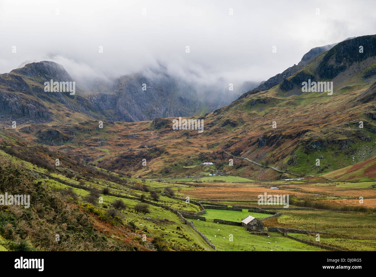 View up Nant Ffrancon valley to Cwm Idwal and Glyderau covered in low cloud in mountains of Snowdonia North Wales UK Britain Stock Photo