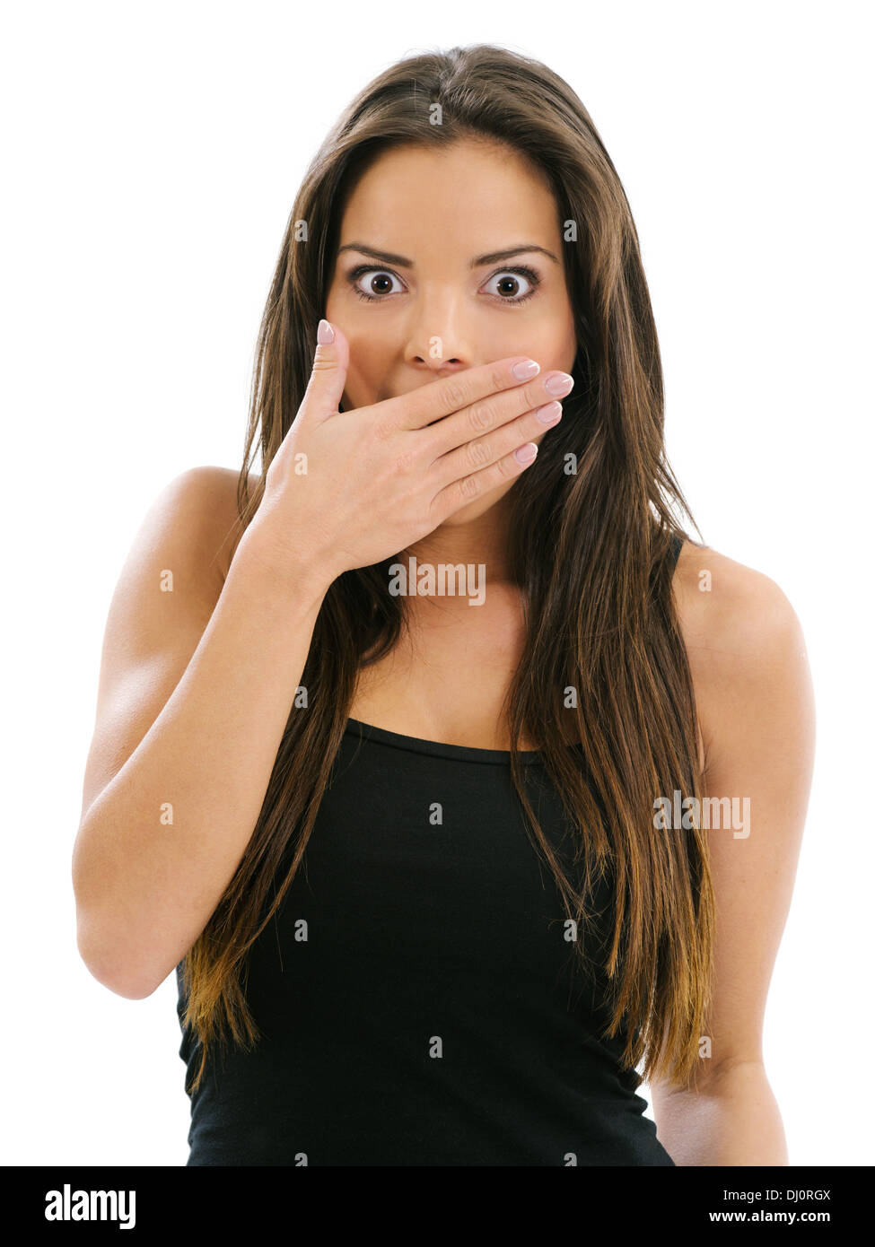 Photo of a beautiful female with her hand over her mouth and eyes wide from shock. Stock Photo