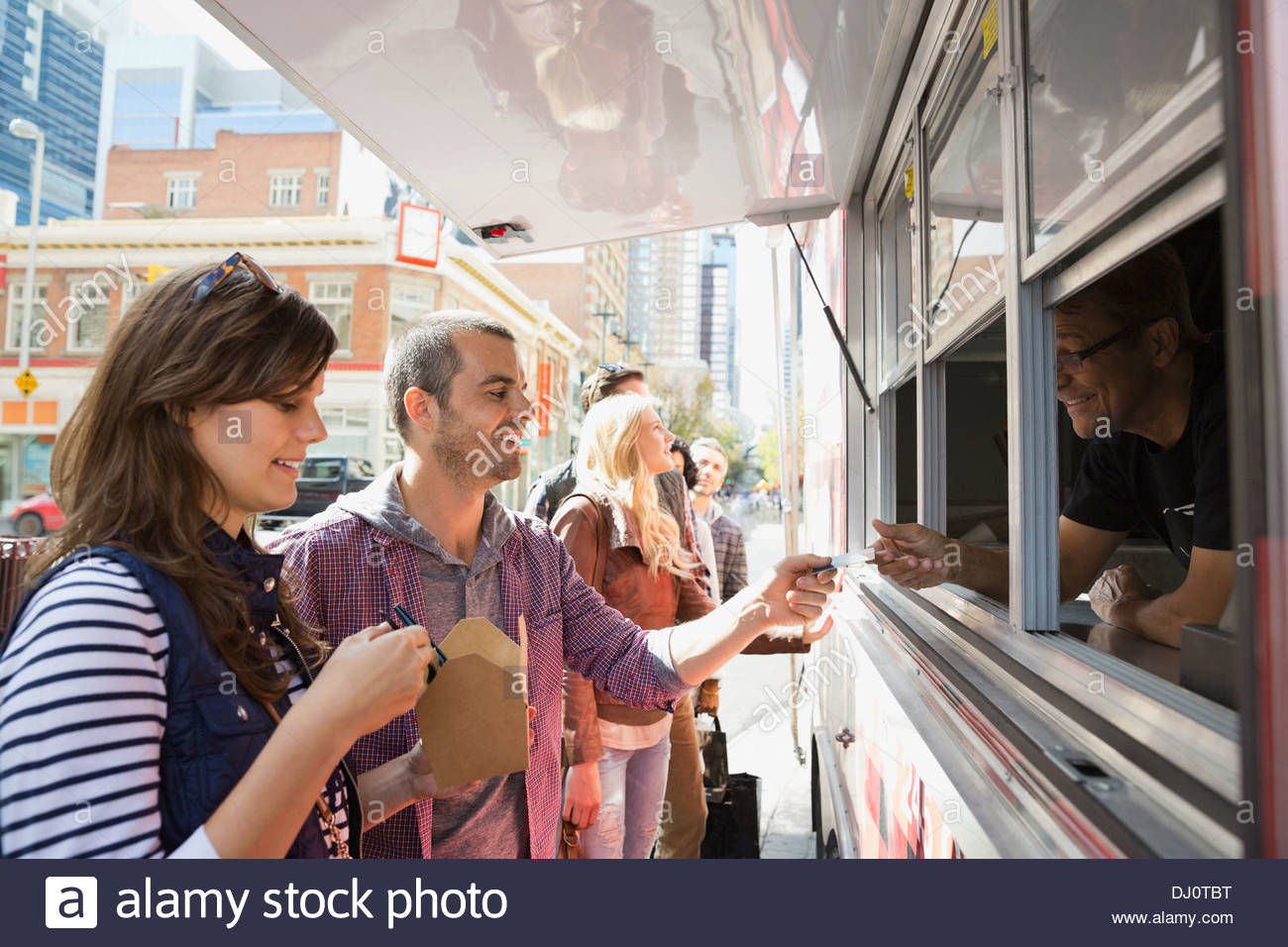 Couple paying for takeaway food Stock Photo