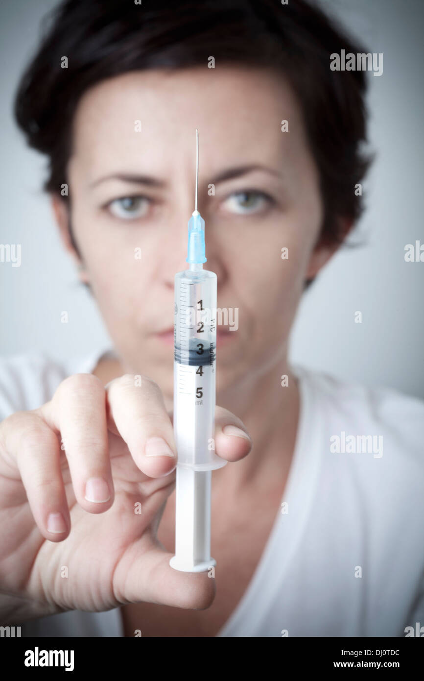 woman with syringe in hand Stock Photo Alamy