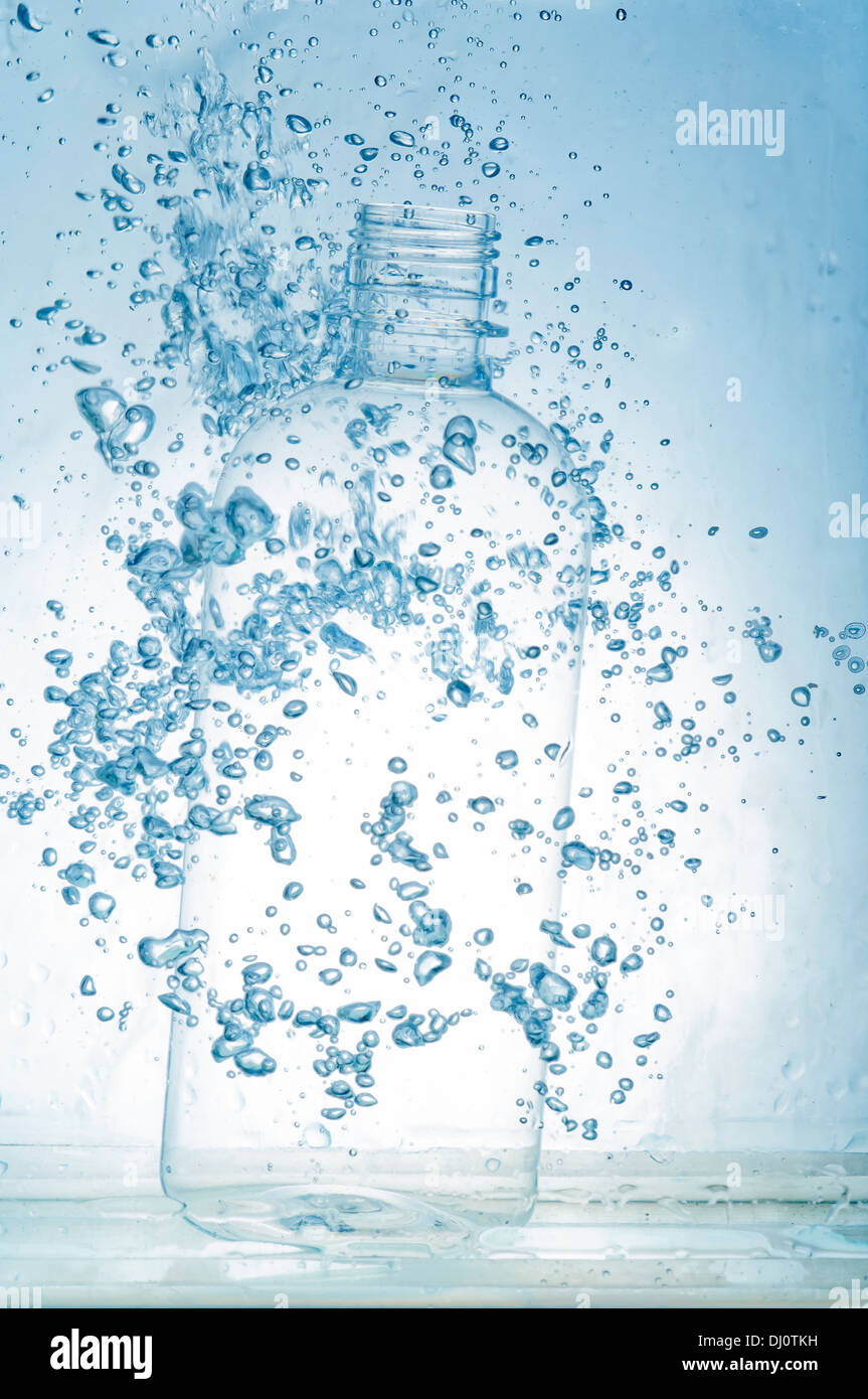 bottle falling and sinking in blue water Stock Photo Alamy