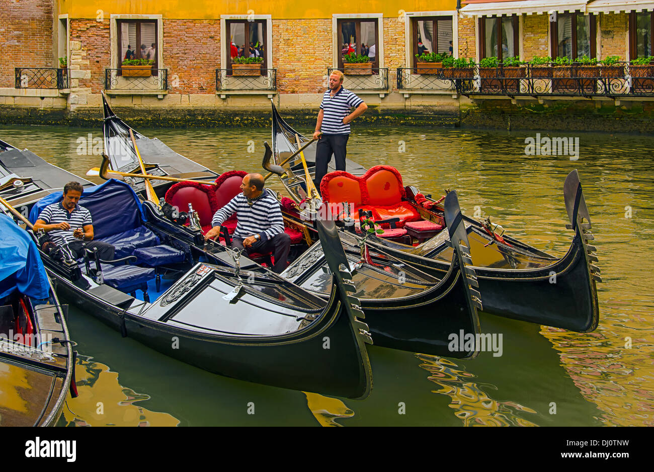 Gondoliers relaxing between canal tours in Venice, Italy. Stock Photo