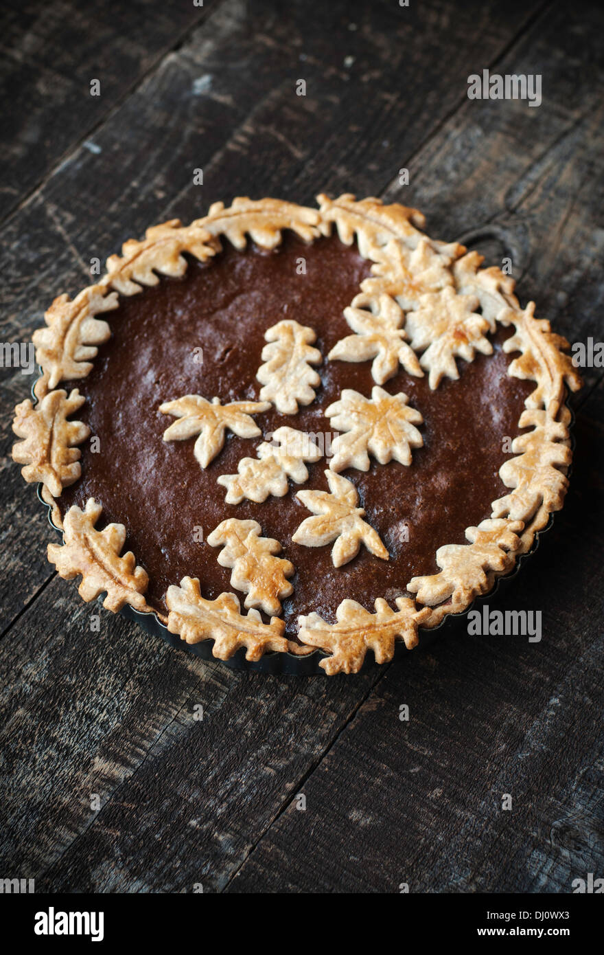 Falling leaf themed pumpkin pie with golden pastry Stock Photo