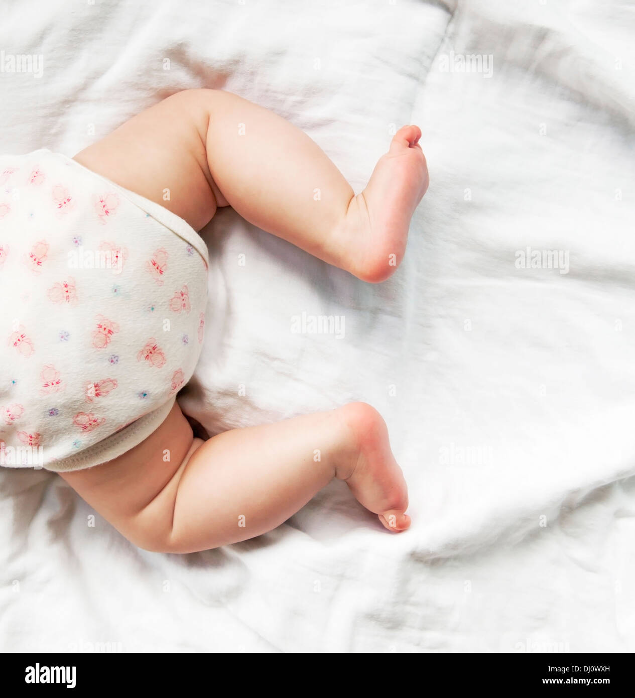 Baby's butt, legs and feet Stock Photo