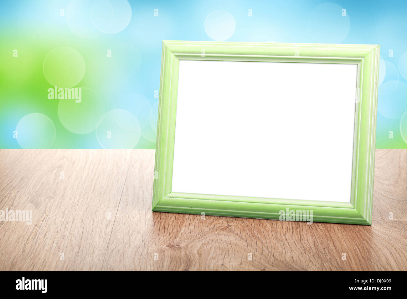 Photo frame on wood table over sunny day bokeh background Stock Photo