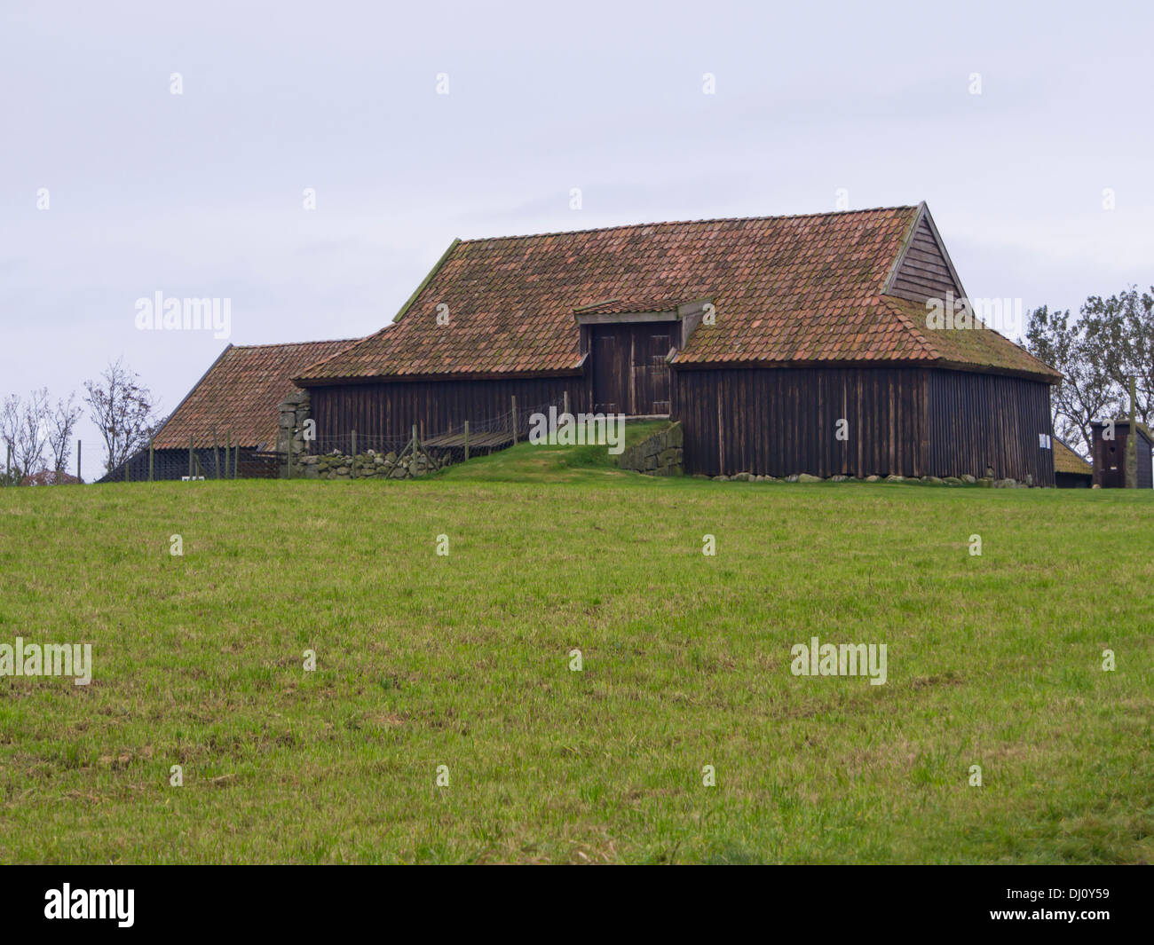 Old wooden barn with tiled roof in traditional building style of Jæren Norway , near Stavanger, conservation project at local Jæren museum Stock Photo