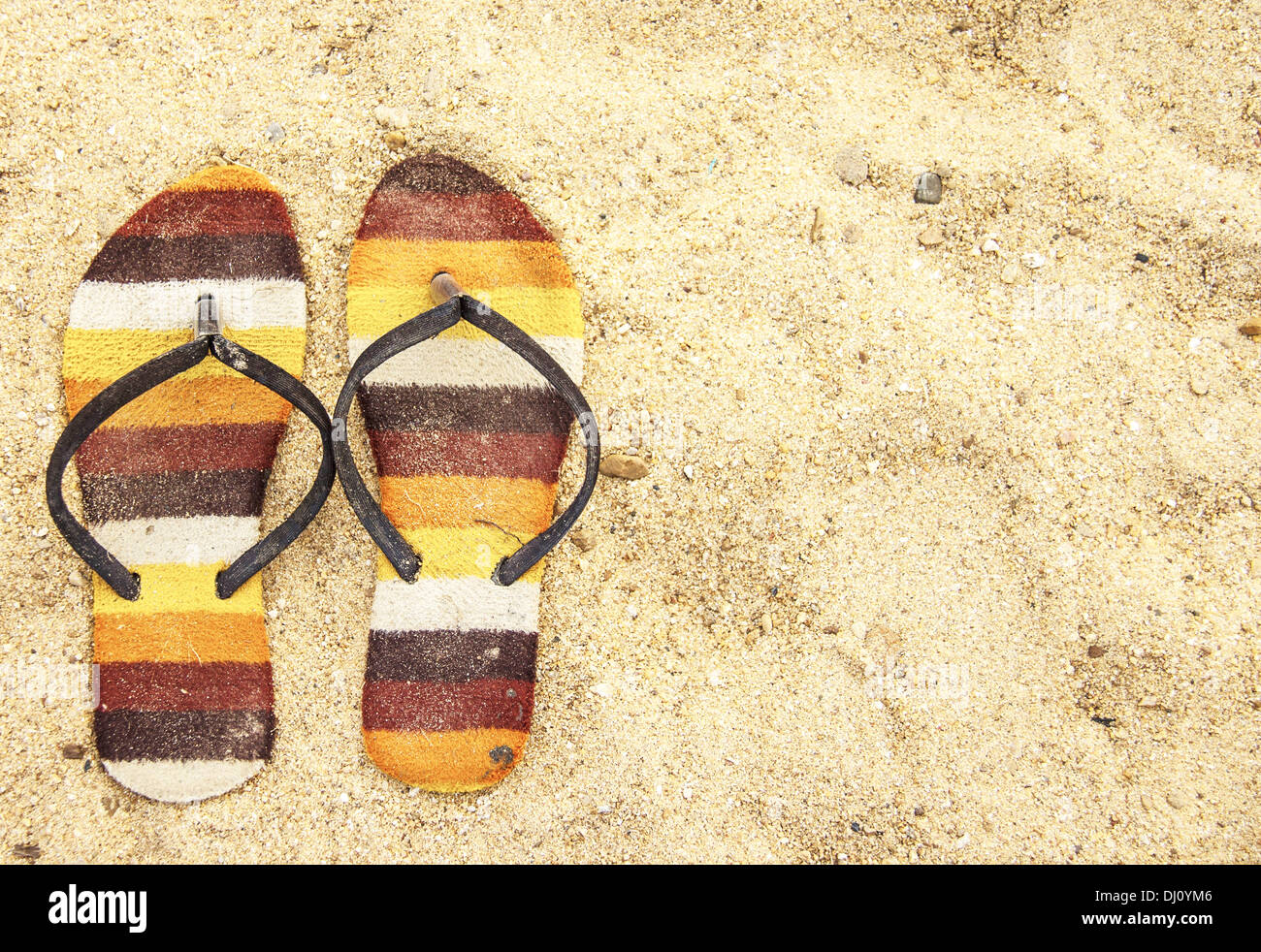 old sandal on the sand, top view Stock Photo