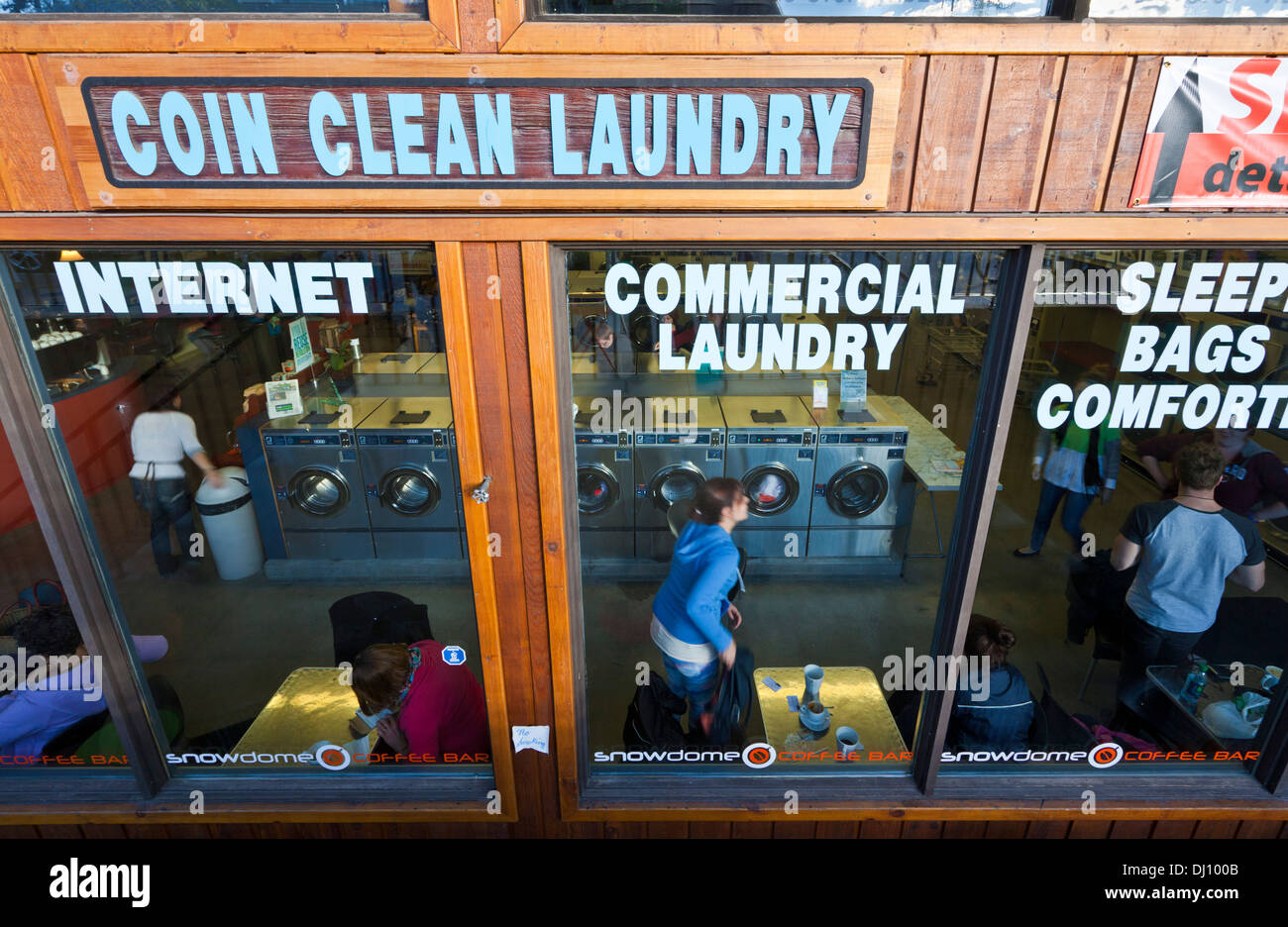 People in the Coin operated laundry laundrette laundromat doing their laundry in Jasper Alberta Canada Stock Photo