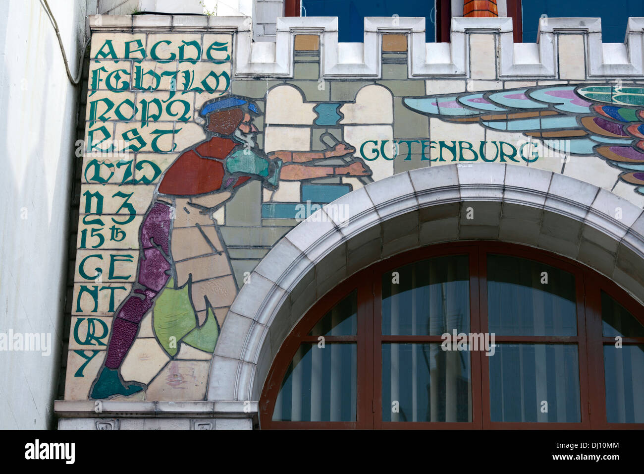 A mural depicting Johann Gutenberg at a printing press, on the facade of the former Edward Everard's print works, Bristol. Stock Photo