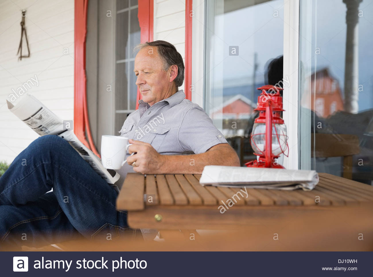 Senior man reading newspaper with coffee Stock Photo