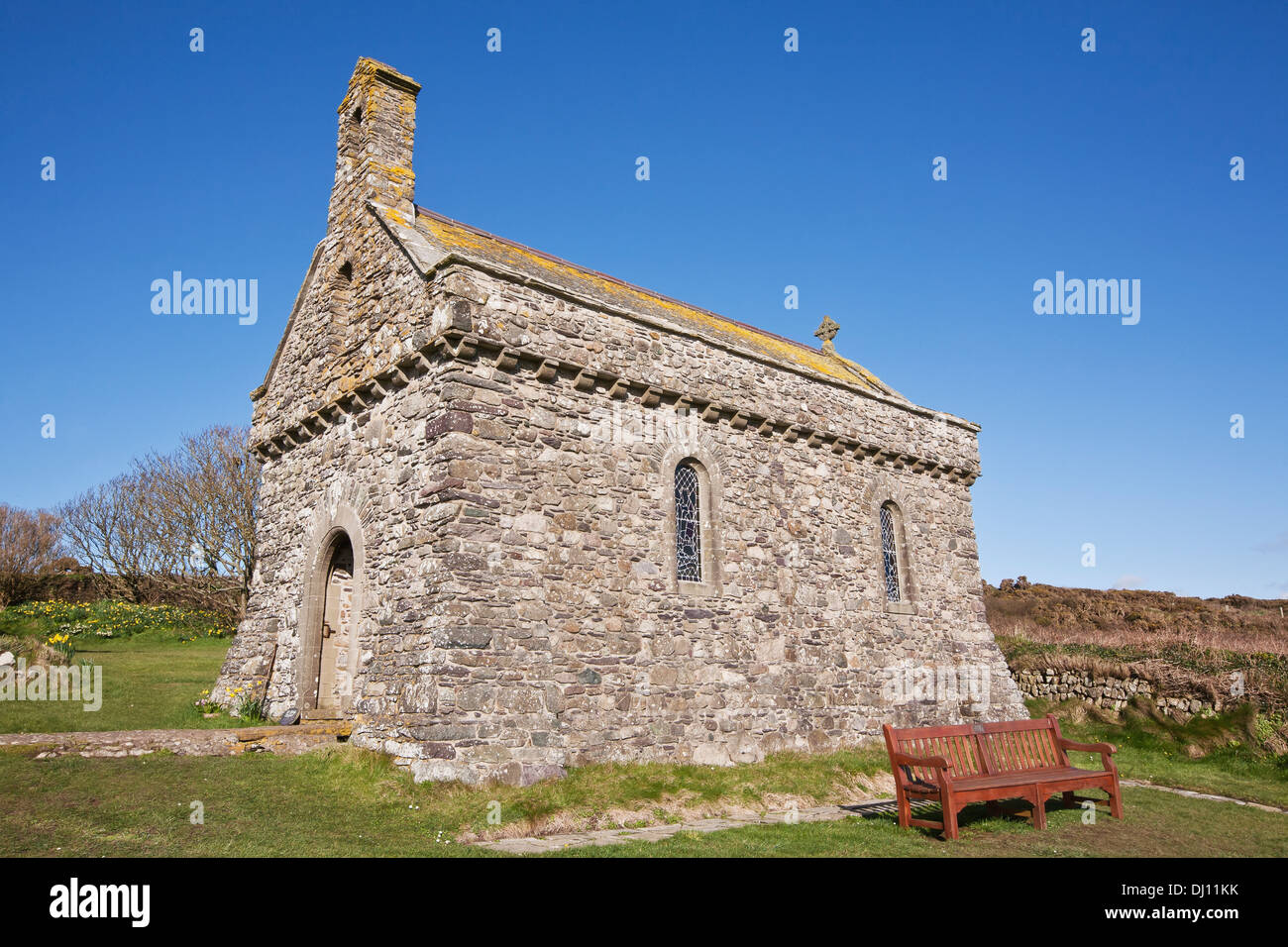 An Old Stone Church With A Bench And Blue Sky Stock Photo - Alamy