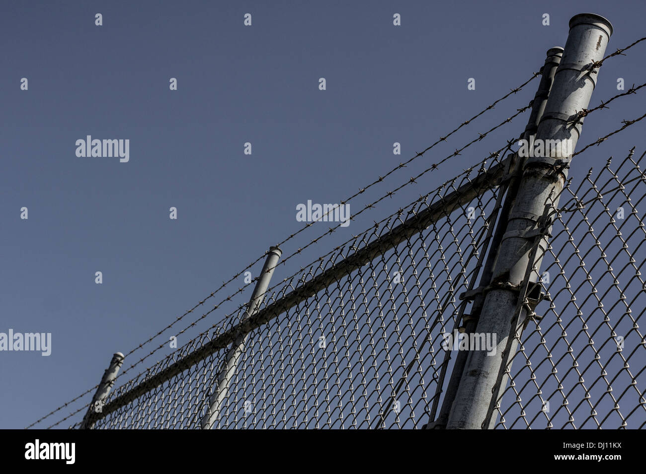 Chain link fence with barbed wire Stock Photo