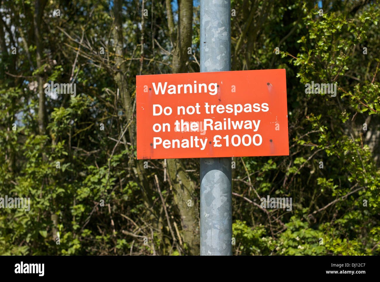 Red railway warning sign. Do not trespass on the Railway Penalty £1000 ...