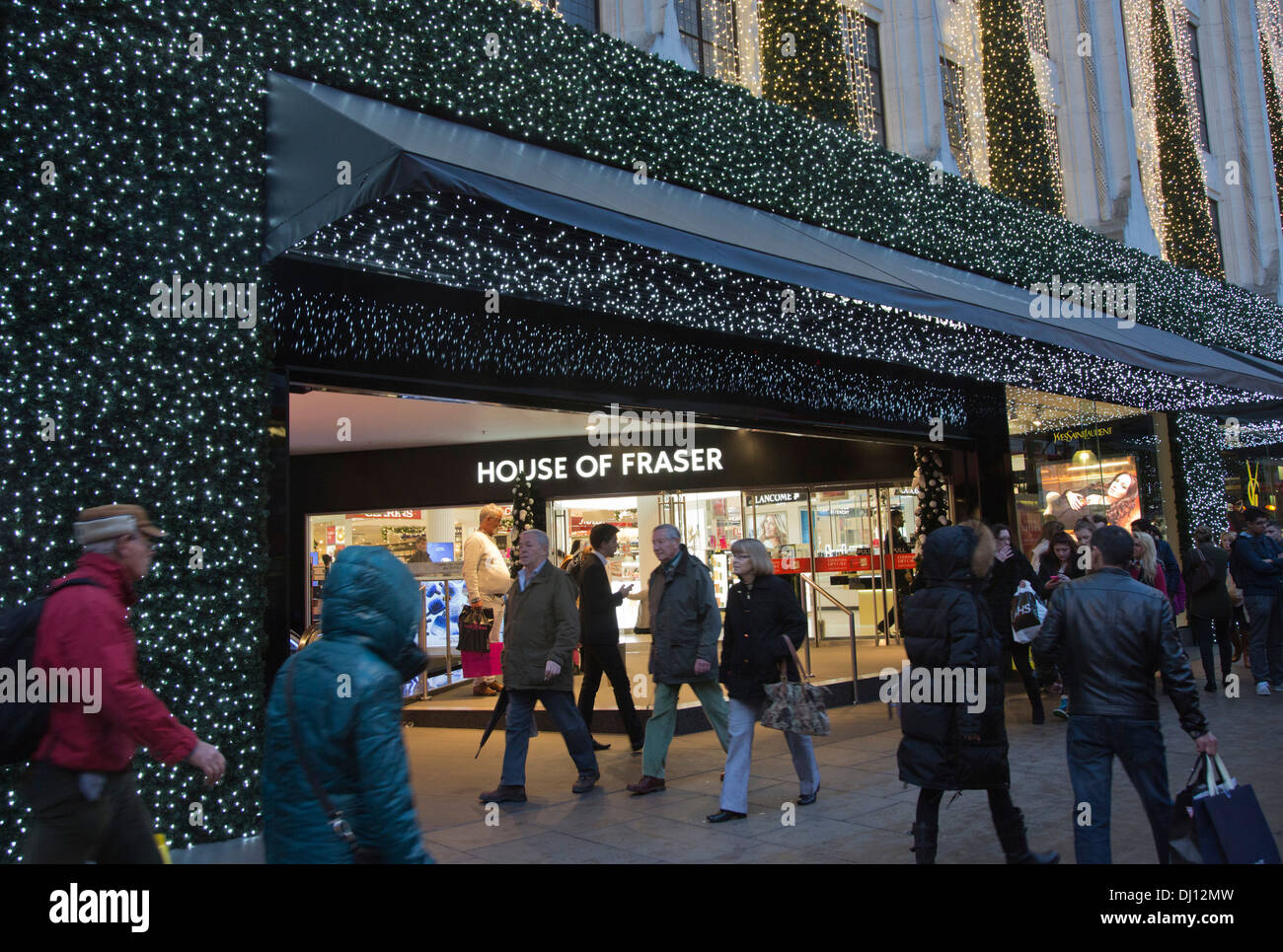 Christmas shopping in Oxford Street, passers-by outside the House of Fraser department Store Stock Photo