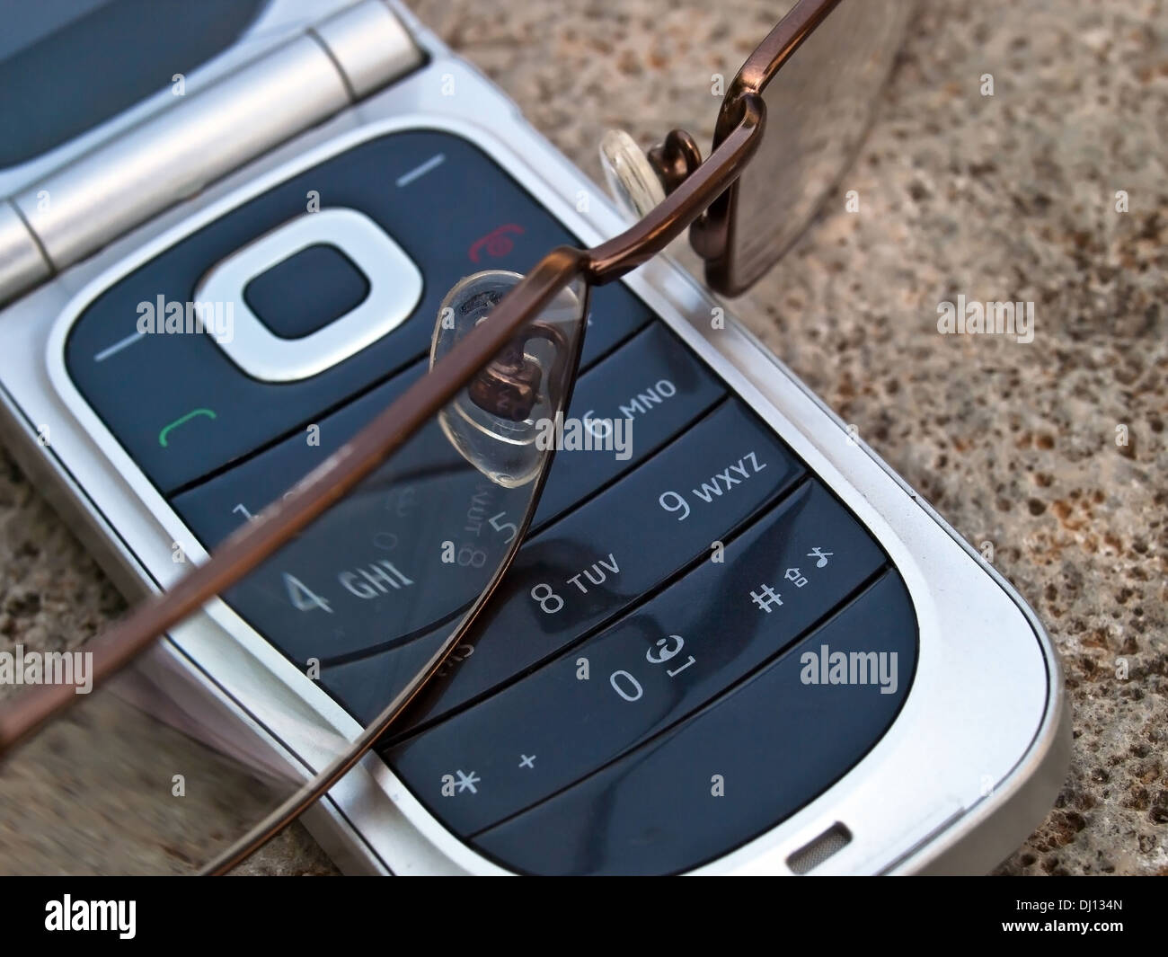 cellular phone and eye glasses Stock Photo