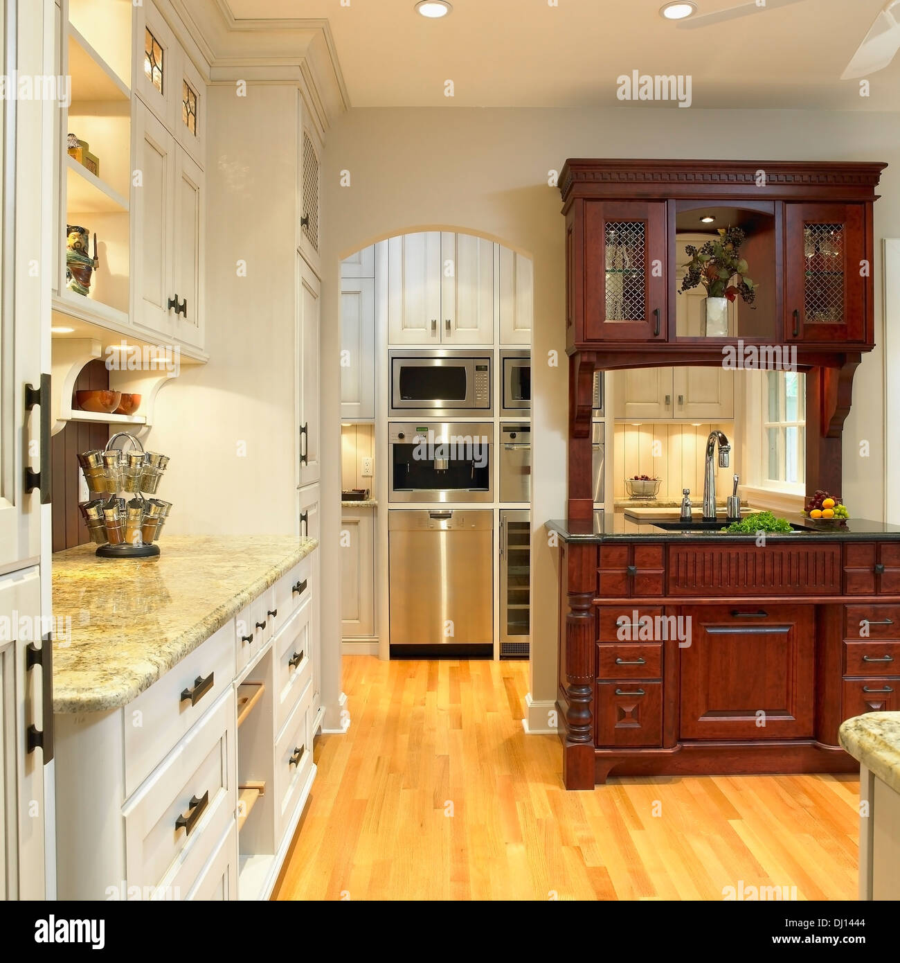 Traditional Kitchen With Cream Cabinets And Built-In Dark Wood Hutch; Victoria, Vancouver Island, British Columbia, Canada Stock Photo