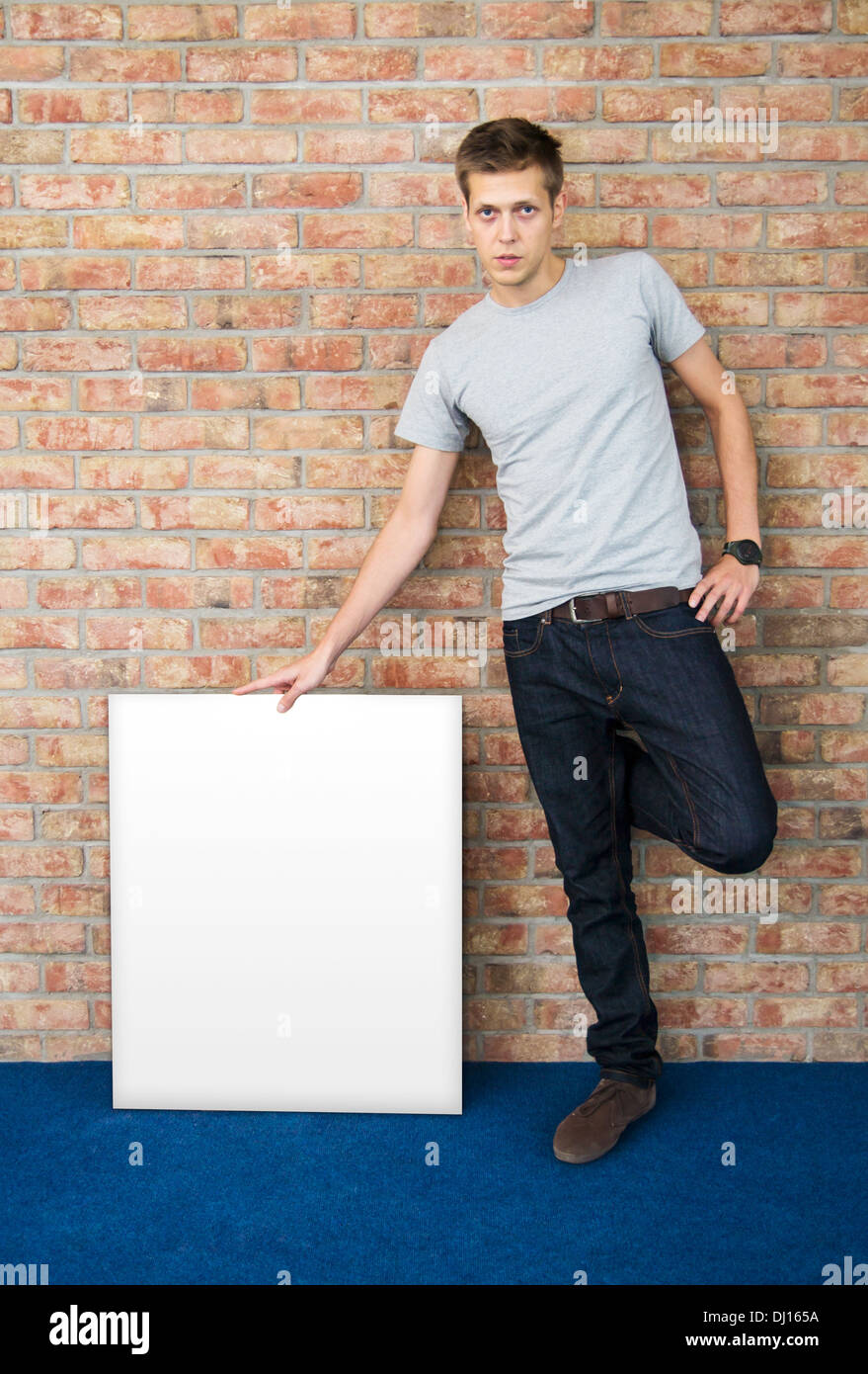 Young man holding blank whiteboard Stock Photo