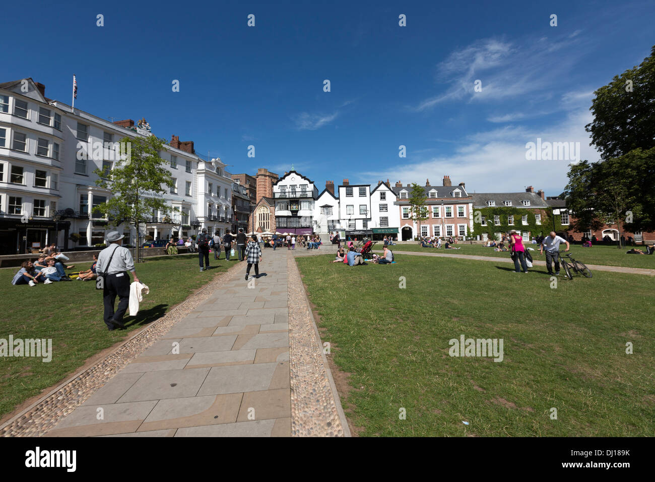 People lying on the grass in a Sunny day Exeter Cathedral Yard Stock Photo