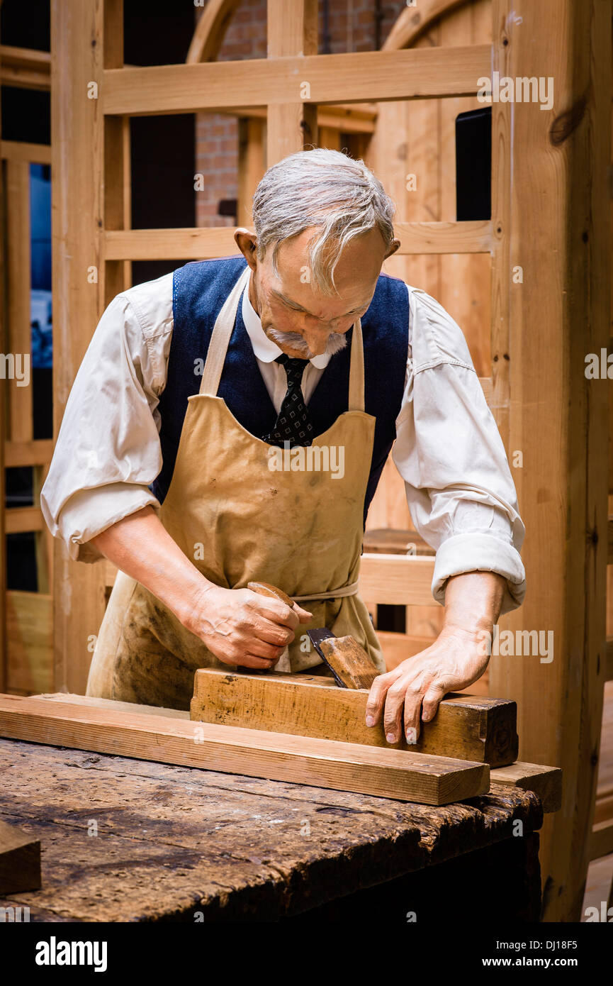 Replica of railway carriage builder planing wood in STEAM museum in Swindon UK with most realistic model of craftsman Stock Photo