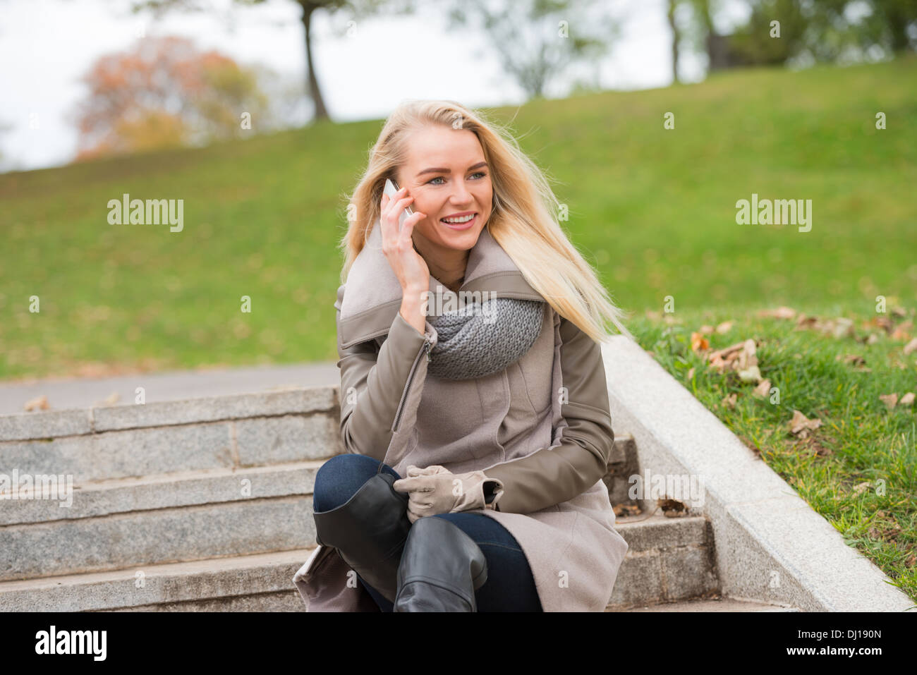 Beautiful, happy young woman with blonde hair relaxing in a park Stock ...
