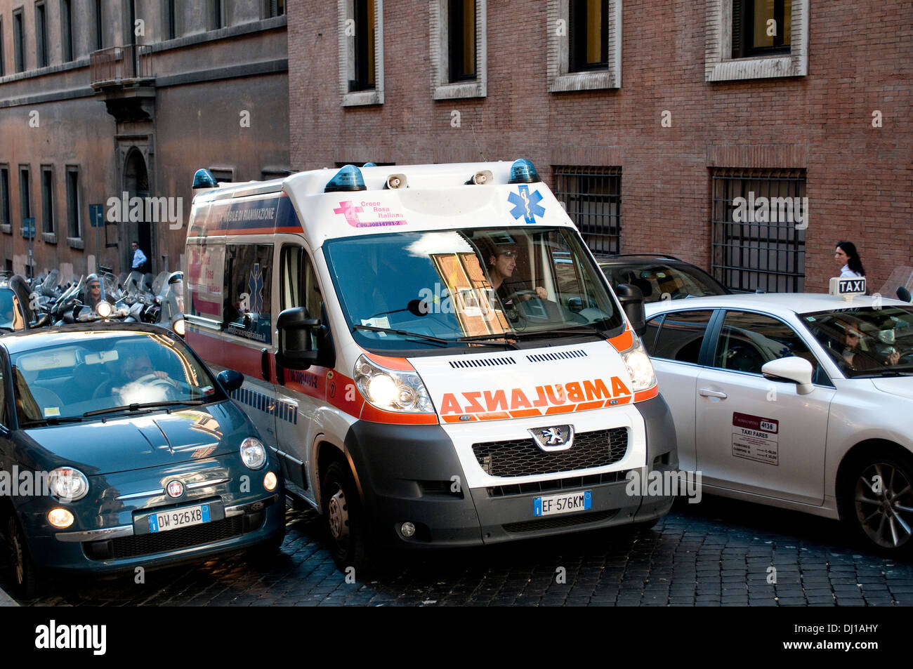 Ambulance on call trying to inch its way through traffic in Via Quattro Fontane in rione Trevi, Rome, Italy Stock Photo