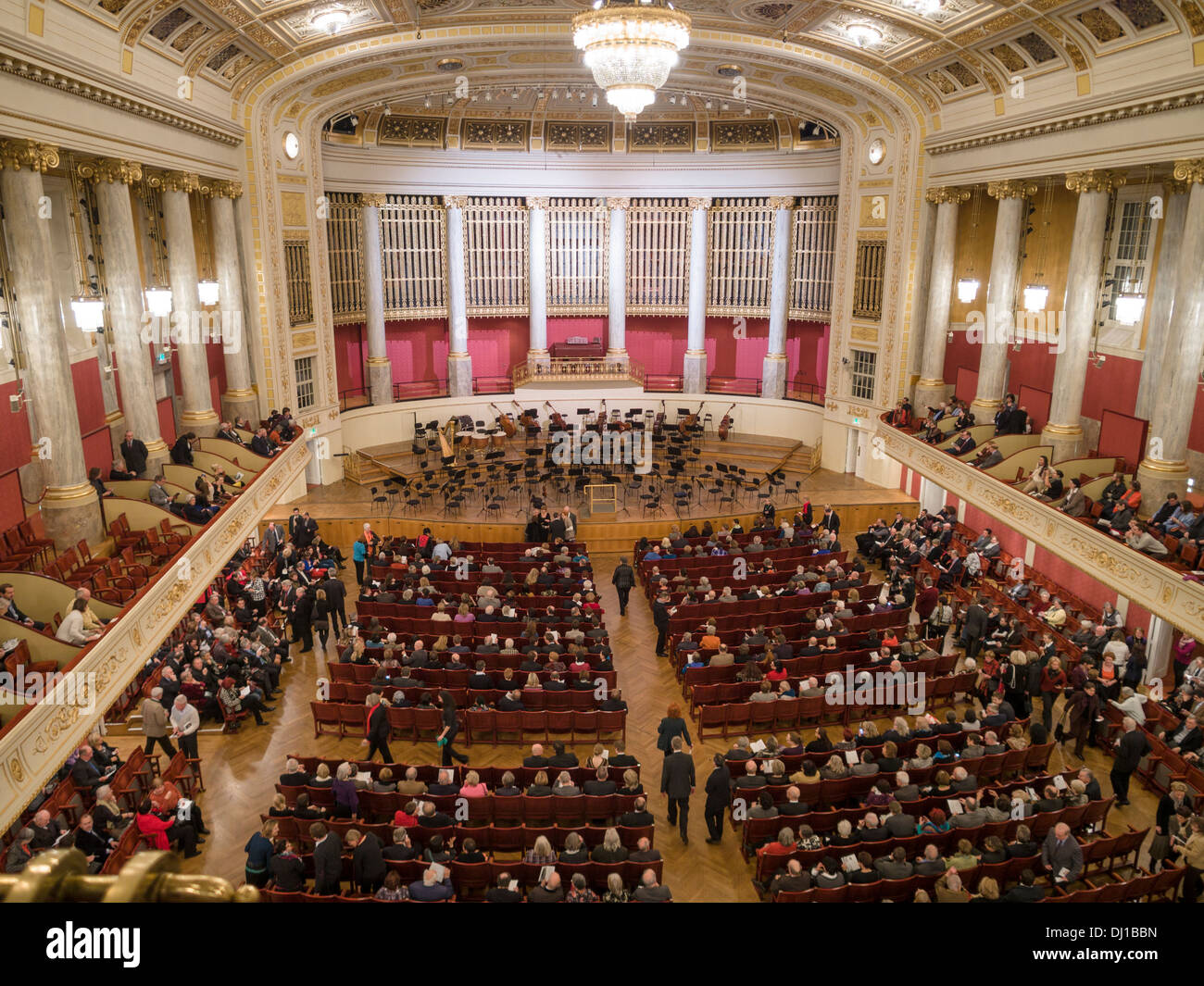 Patrons gather for a Concert at Wiener Konzerthaus. The seats fill up with concert goers but the stage is mostly empty. Stock Photo