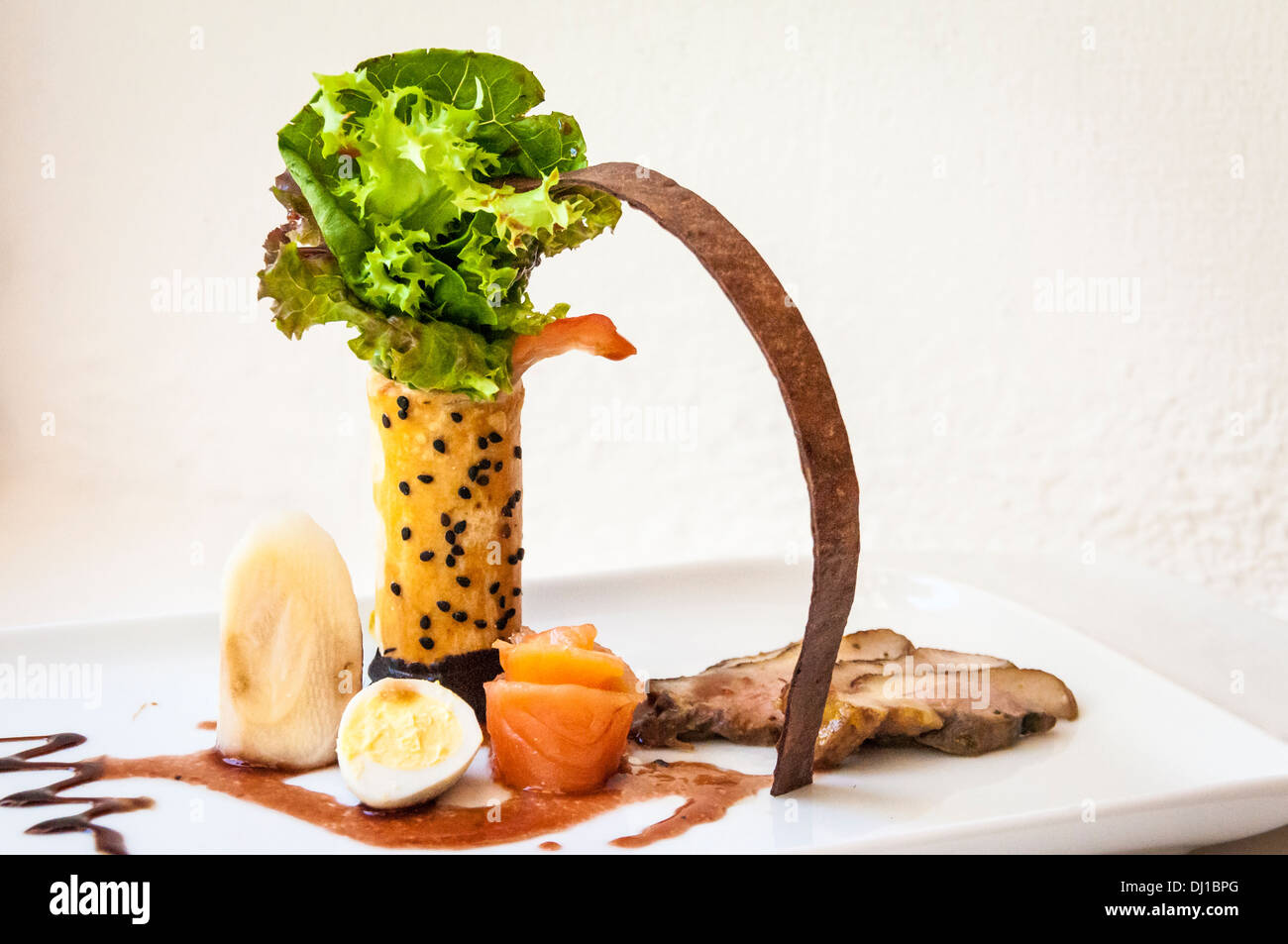 The Royal Resort chef's creation featuring duck, salmon, quail egg and palm heart; Playa del Carmen, Riviera Maya, Mexico. Stock Photo