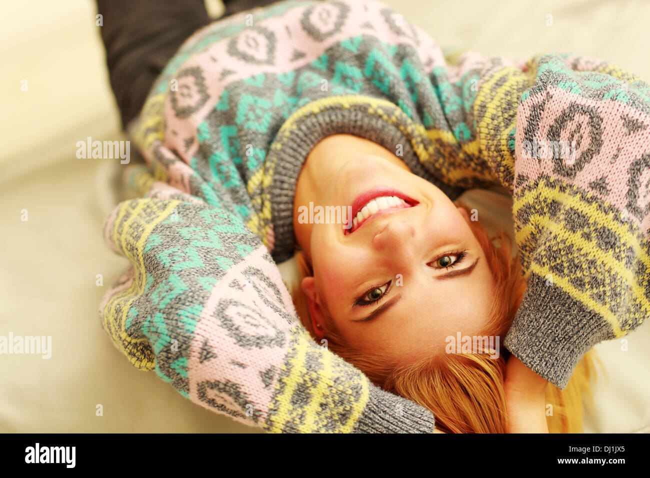 portrait of a young smiling woman lying on the bed Stock Photo - Alamy