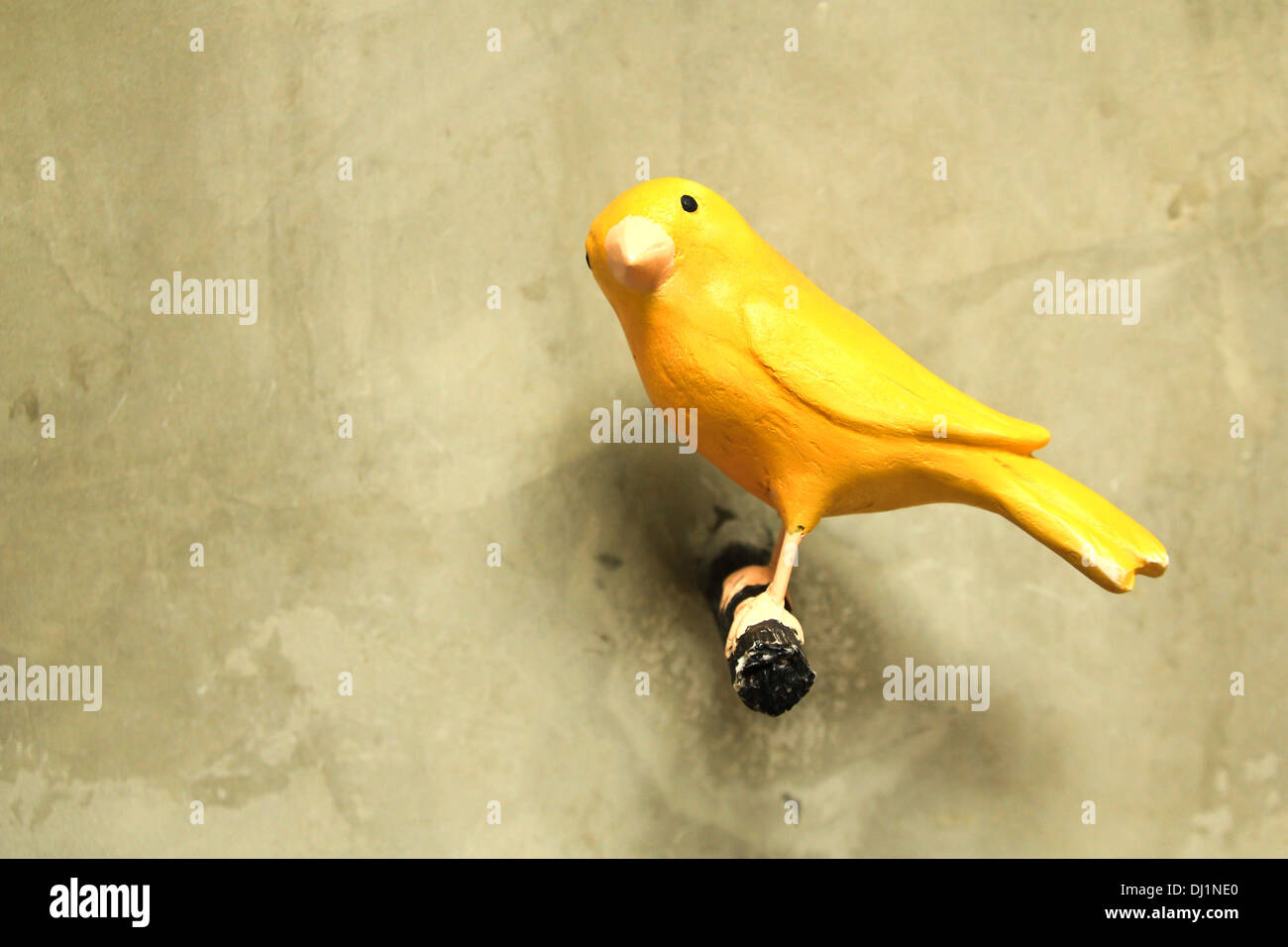 Bird sculpture colorful on wall Stock Photo